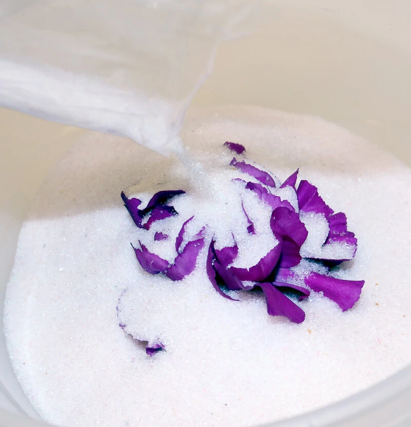 Pour Flower Drying Art™ Silica Gel around the flowers to dry flowers in a microwave.